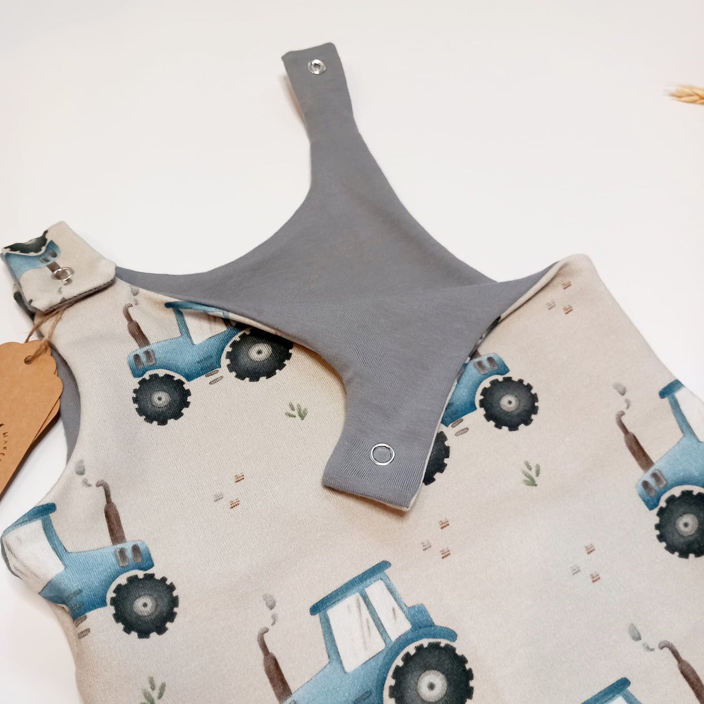 Blue tractor dungaree romper