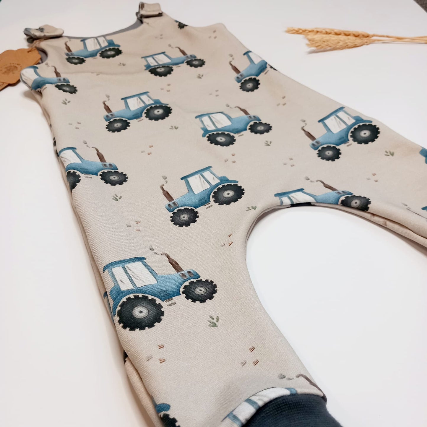 Blue tractor dungaree romper