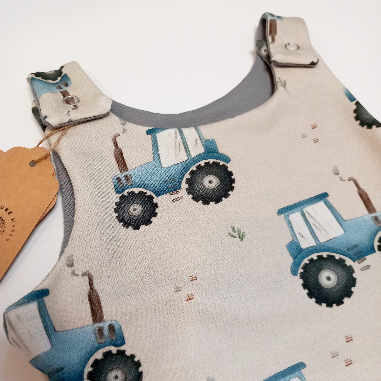 Blue tractor dungaree romper