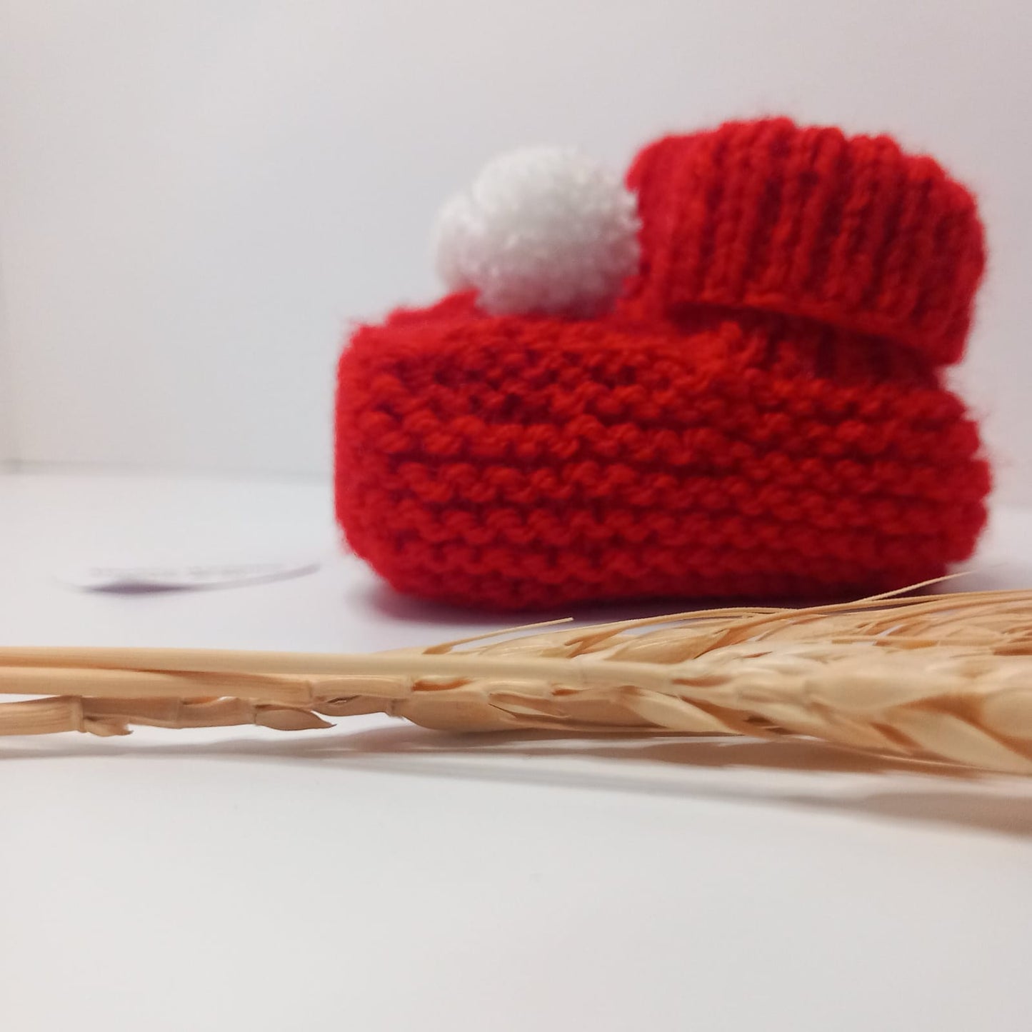 Hand knitted bootees (Red and white pom pom)