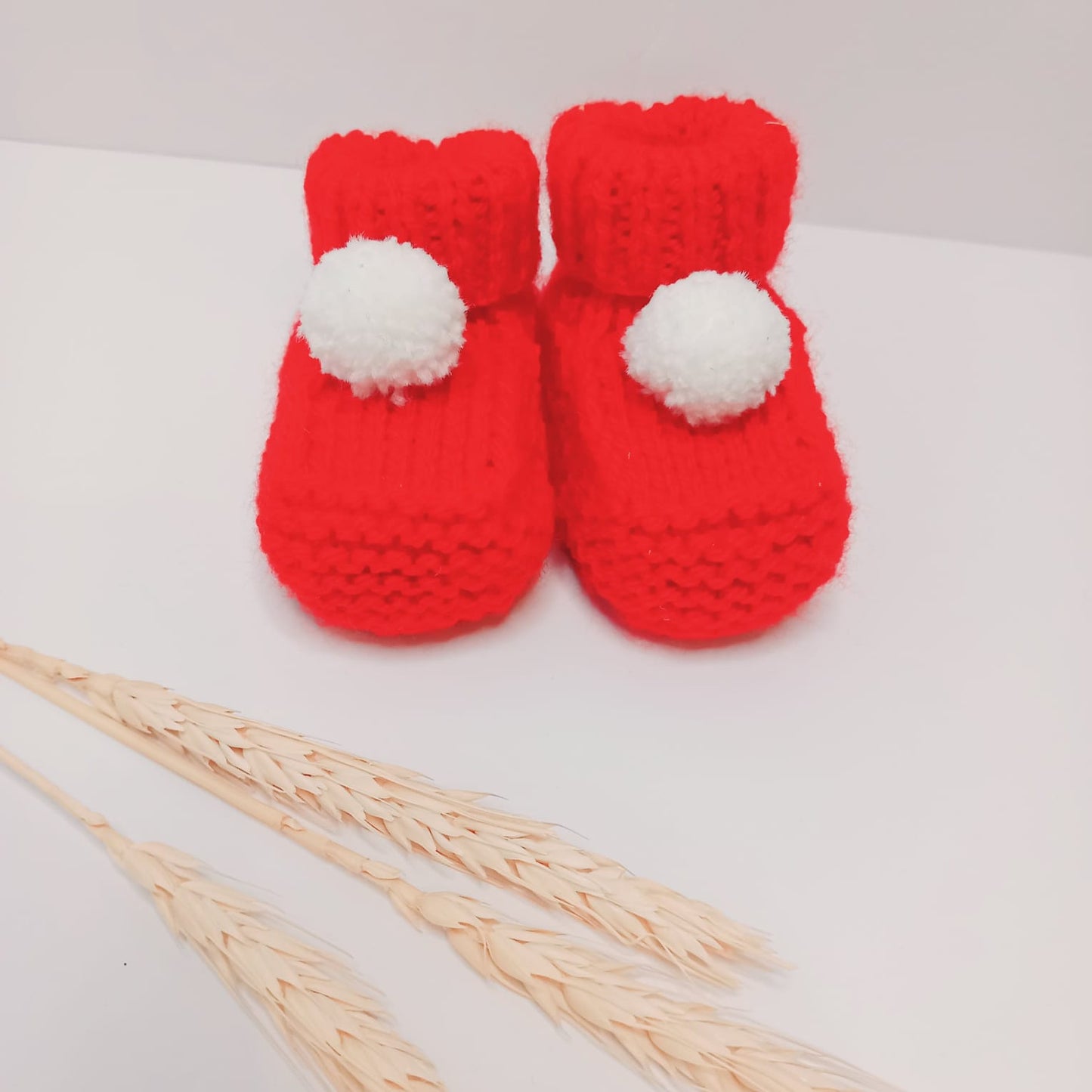 Hand knitted bootees (Red and white pom pom)